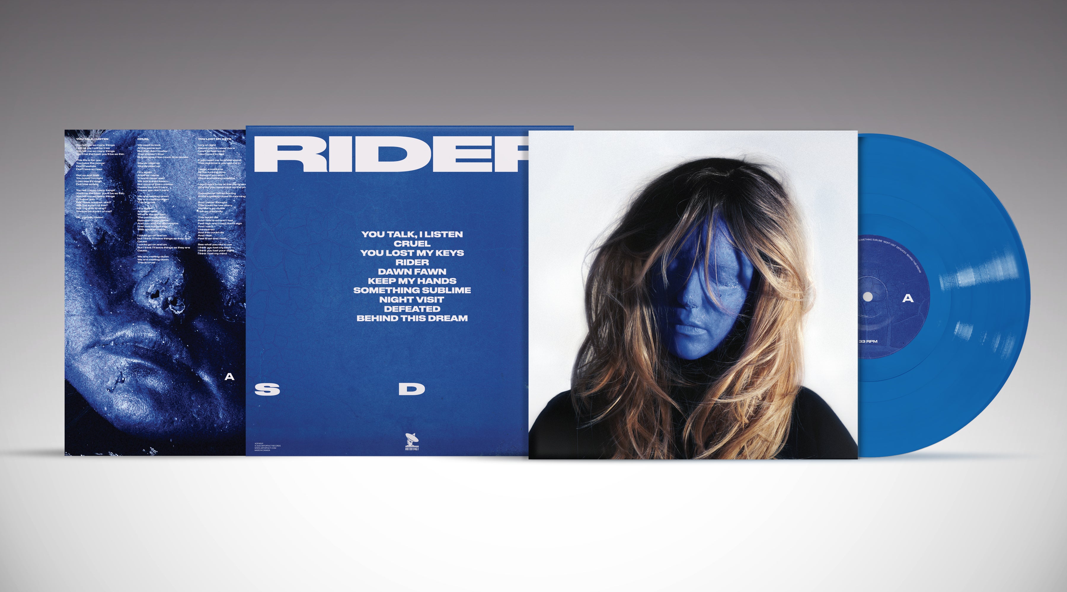 Vinyl record with blue cover and white text, featuring a person's face and album title 'Rider'.