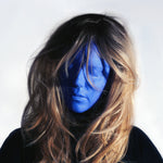 Person with blue face paint and long hair against a white background
