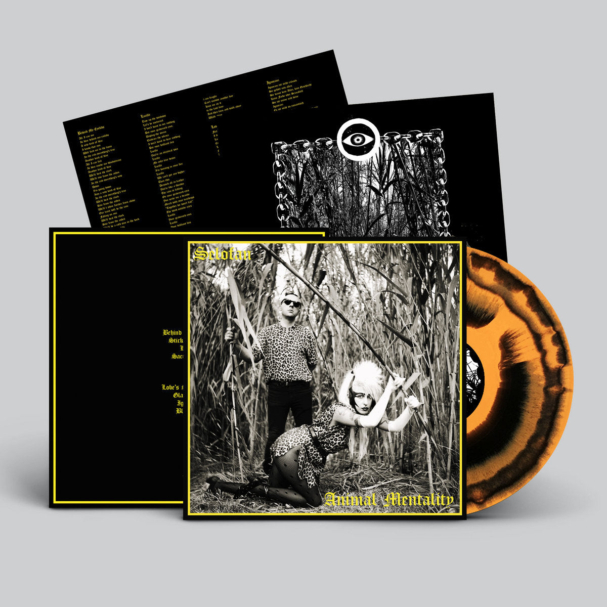 Vinyl record with black and white cover art and additional black sleeves on a gray background