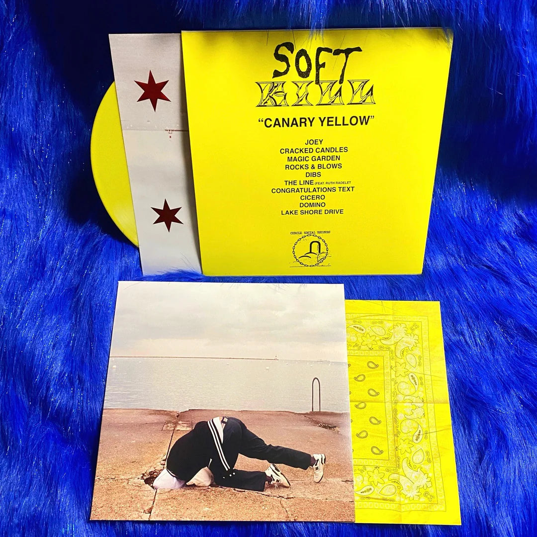 Soft Kill - Canary Yellow (Limited Edition) yellow vinyl record with yellow yellow back cover and additional inserts on a blue textured background
