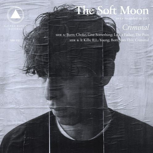 Album cover for 'Criminal' by The Soft Moon with a textured background and face overlay.