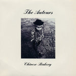 Album cover with a person wearing a hat and plaid shirt, text 'The Auteurs' and 'Chinese Bakery' on a light background.