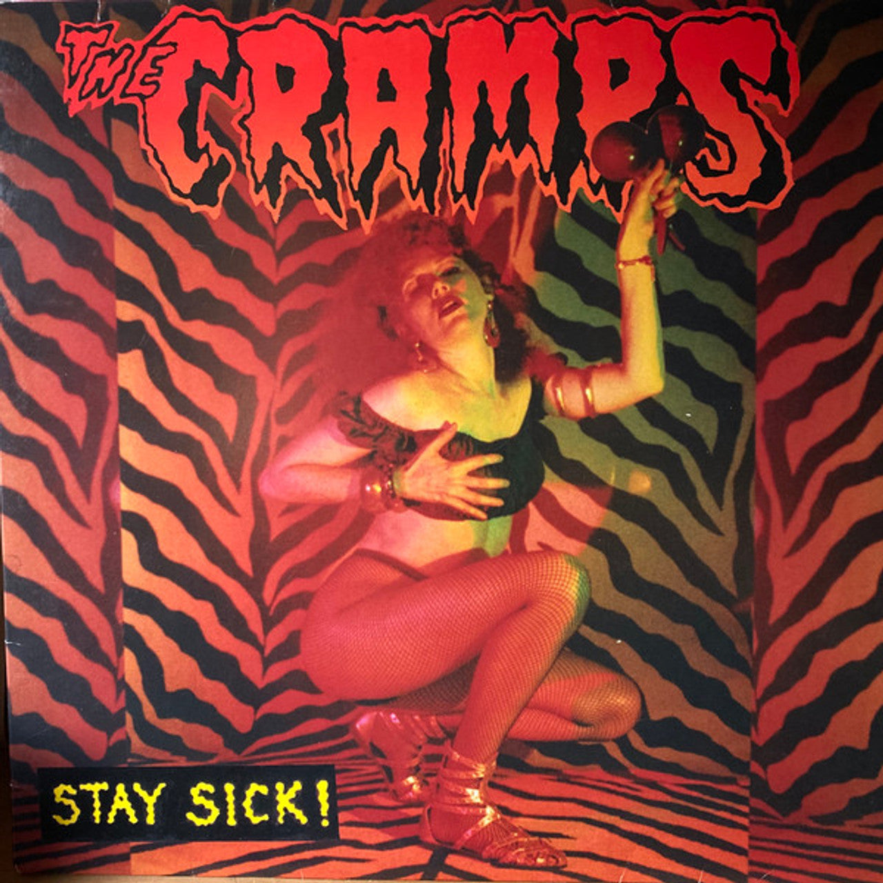 Album cover for 'Stay Sick!' by The Cramps with a person in a zebra-patterned room.