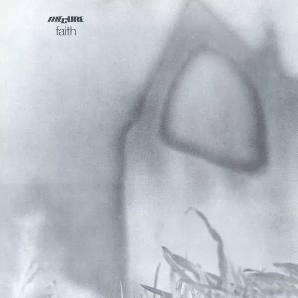The Cure - Faith album cover with a stylized face and text 'faith' on a gray background