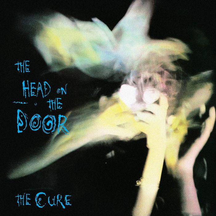 Album cover for 'The Head on the Door' by The Cure with a blurred hands.
