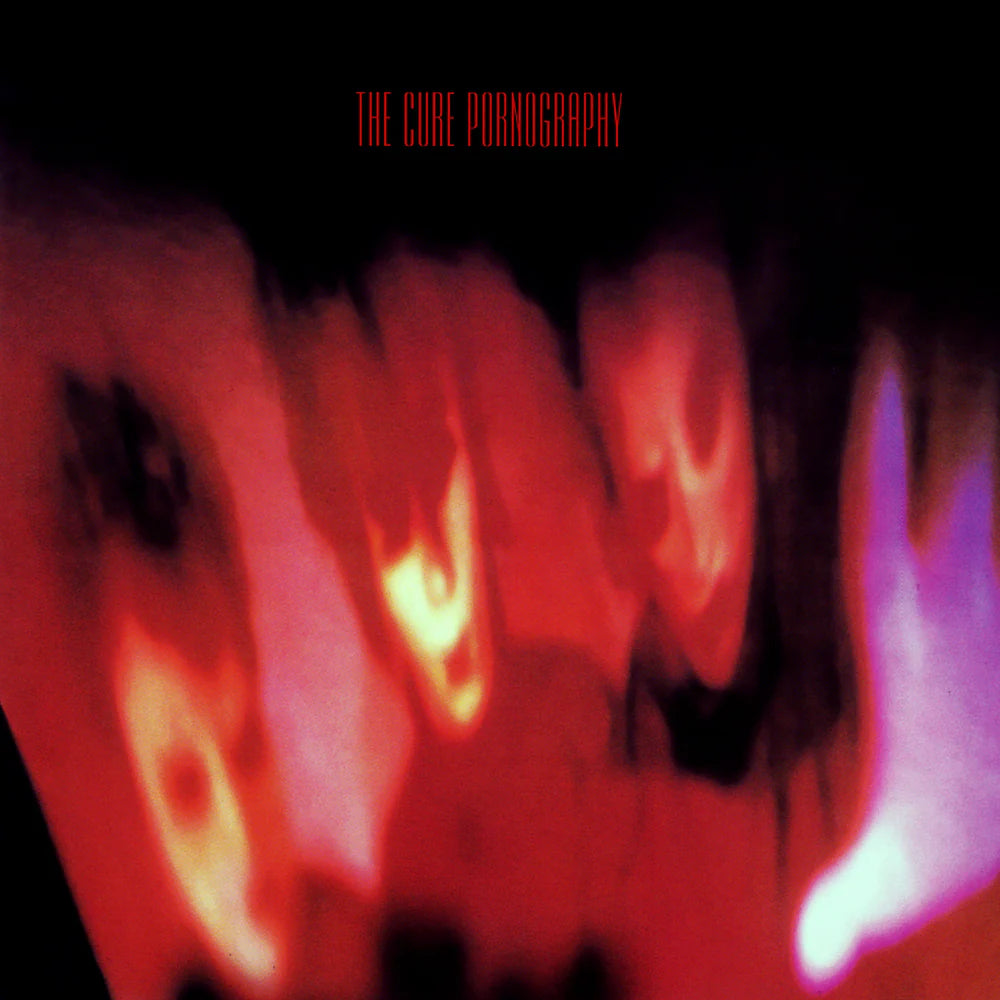 Album cover with abstract design and text 'The Cure Pornography' on a dark background