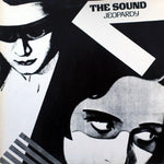 Black and white illustration of a woman with a mask and a man with a hat, with text 'The Sound Jeopardy' above.