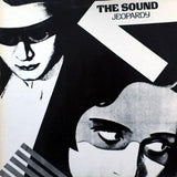 Black and white illustration of a woman with a mask and a man with a hat, with text 'The Sound Jeopardy' above.