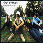 Album cover of 'Urban Hymns' by The Verve with band members sitting on grass.