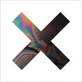 Album cover for The XX - Coexist with an abstract design with a colorful 'X' on a white background