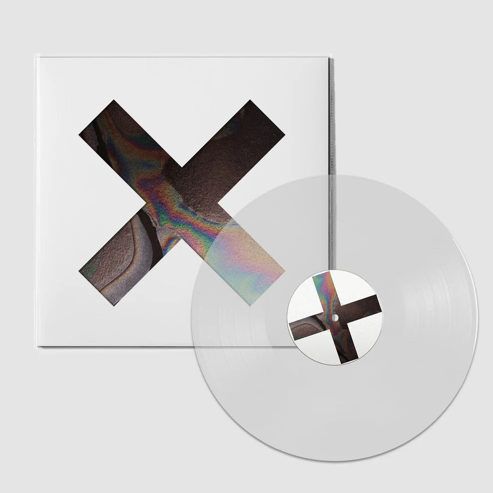 The XX - Coexist album cover and a clear vinyl record with a colorful 'X' design on a white background