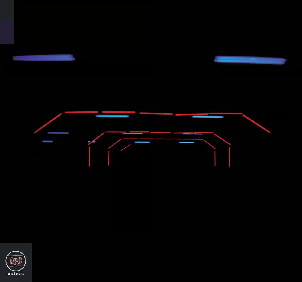 Album cover TR/ST - Joyland  showing a neon sign with red and blue lights on a black background