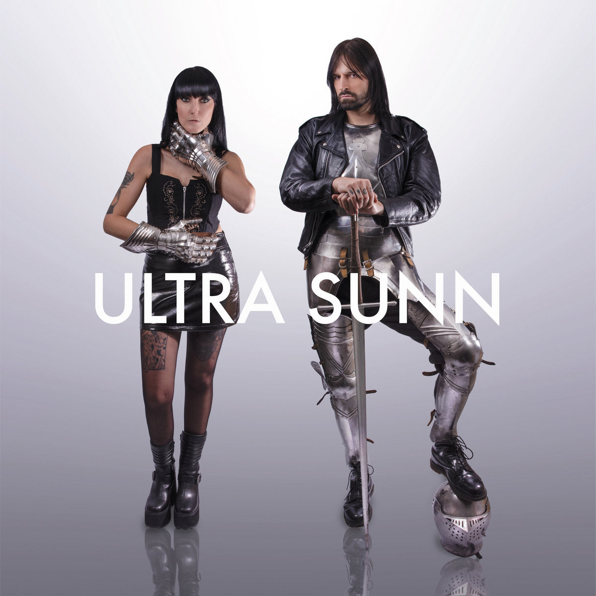 Album cover for Ultra Sunn's "The Beast In You" featuring two people in futuristic outfits with 'ULTRA SUNN' text on a gray background