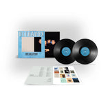 Vinyl records and packaging with 'Ultravox' branding on a white wall background