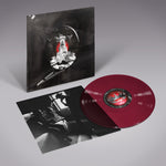 Vinyl record with red disc and black and white cover on a gray background