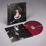 Vinyl record with red disc and black and white cover on a gray background
