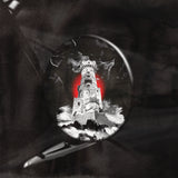 Castle tower with a red circle and lightning effect, viewed through a magnifying glass against a dark background.