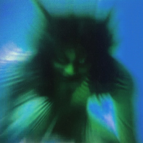 Yves Tumor Safe in the Hand of Love album cover art showing a blurred image of a cat like human with a blue background