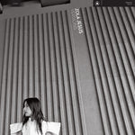 Album cover with a person sitting against a textured wall, featuring 'Zola Jesus * Versions' text.